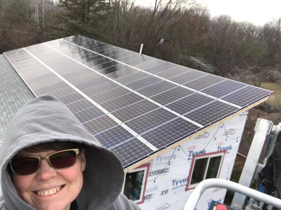 Amy Strutz on a rooftop solar installation